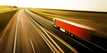 Truck on asphalt road motion blur supply chain improvement