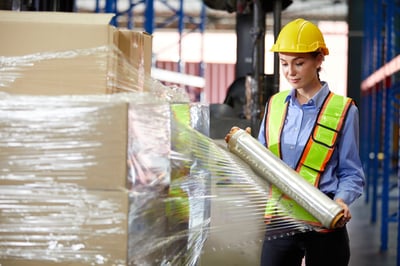 Woman wrapping pallet