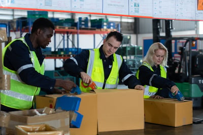 workers packaging shipments as part of transportation and logistics management